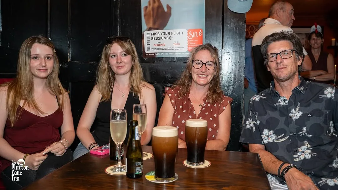 Friends sitting together at a table inside Mutton Lane Inn